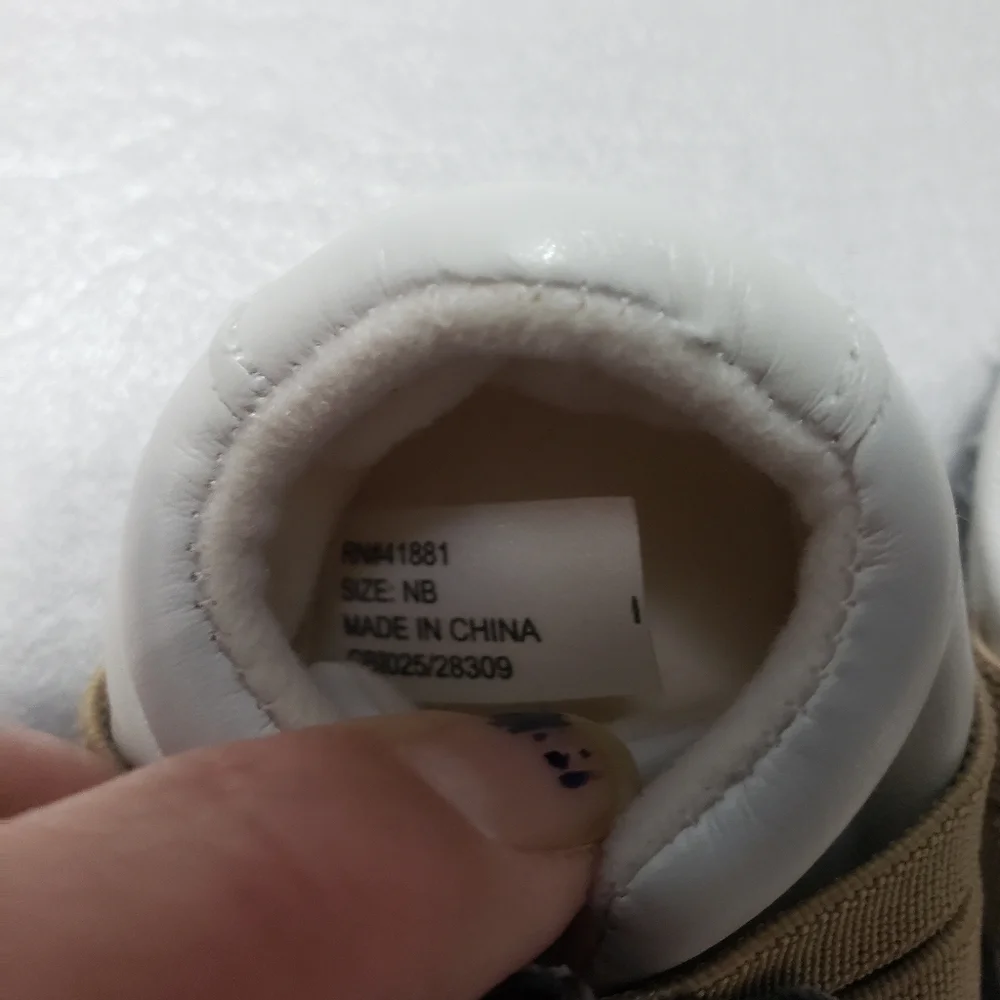 unbranded newborn white and brown gender neutral monkey shoes/slippers